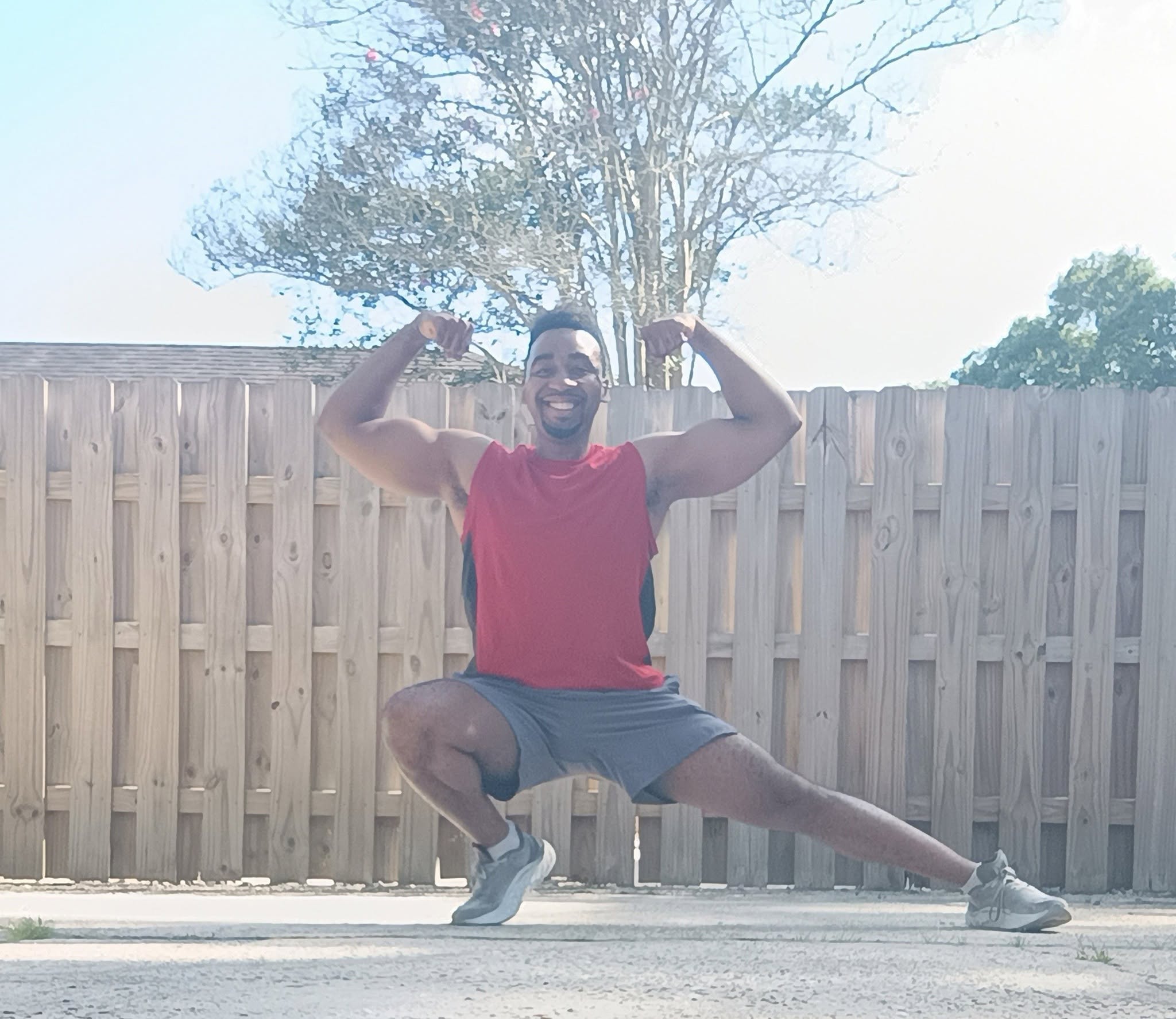 Me flexing outdoors.